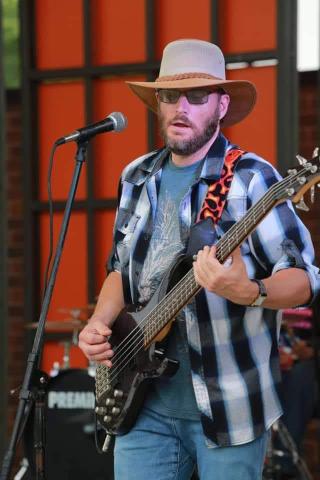 Picture of Danny Mac playing bass on stage 