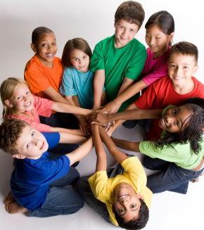 Image of children sitting together with hands in circle